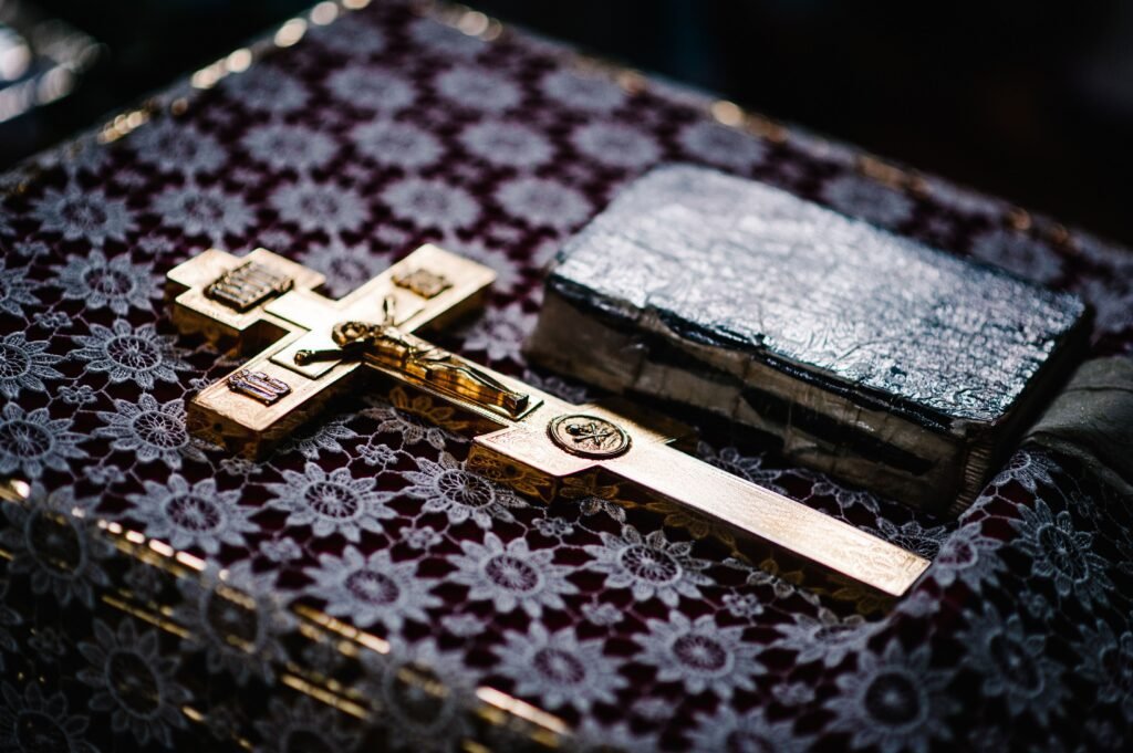 Golden cross and book on cloth.